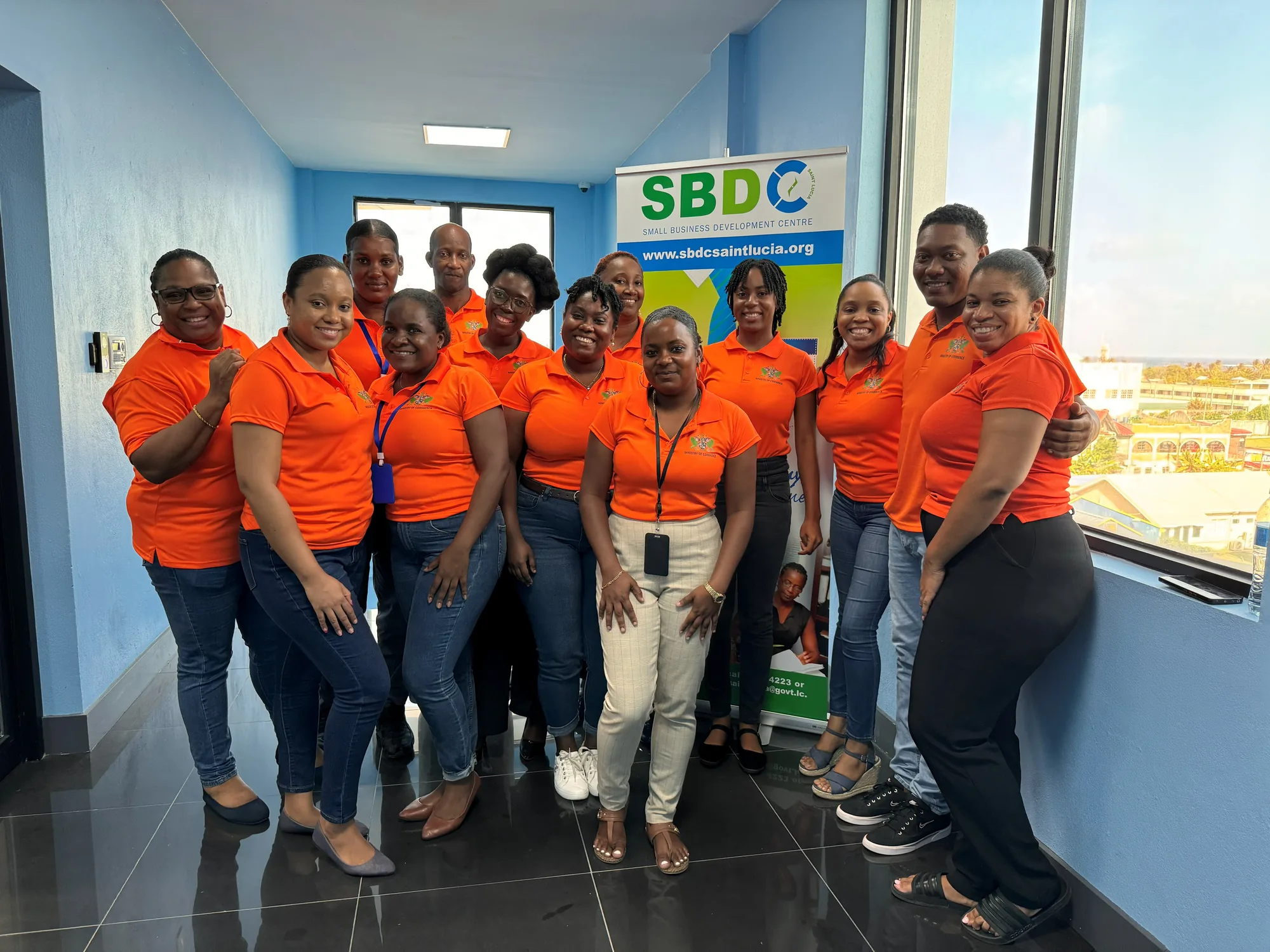 Department of Commerce staff gathered together in matching orange shirts